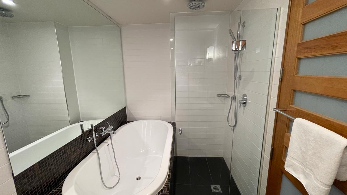 a bathroom with a tub and shower