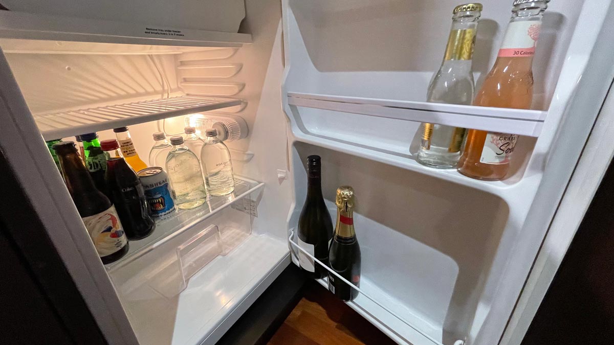 a refrigerator with bottles of alcohol and bottles of beer