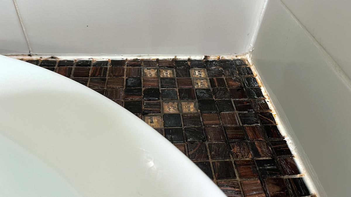 a bathtub with tile floor