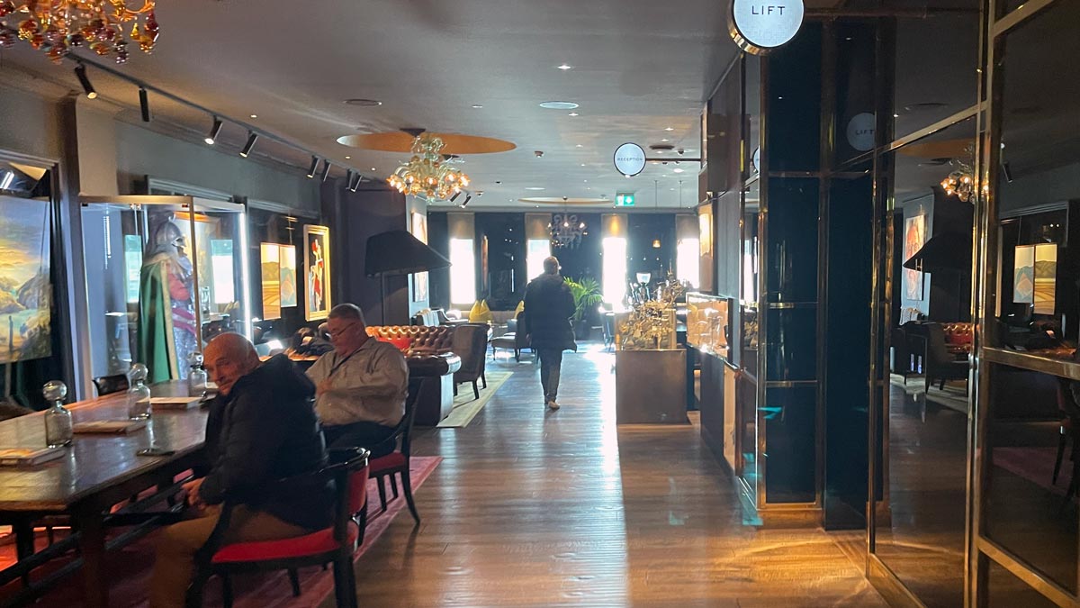 a room with people sitting in chairs and tables