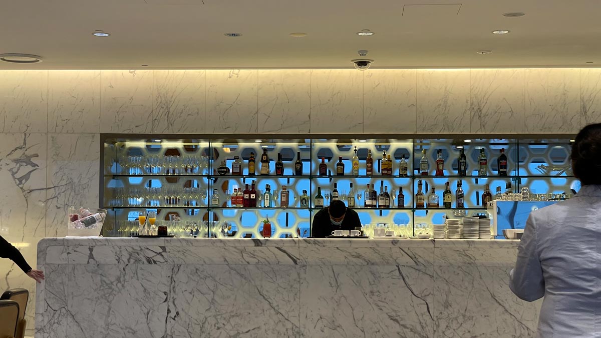 a bar with many bottles on shelves