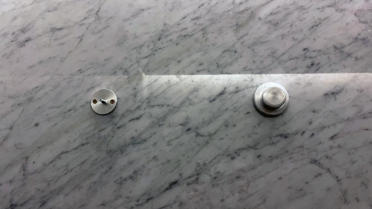 a metal knobs on a marble surface