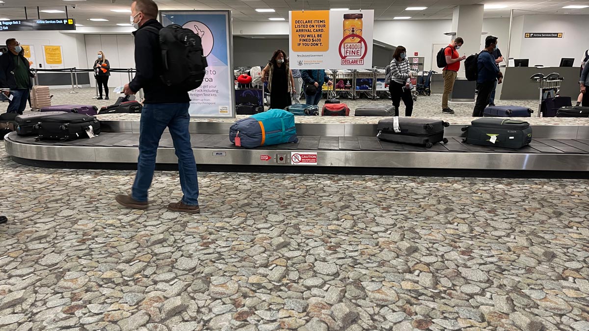people walking on a conveyor belt in a airport