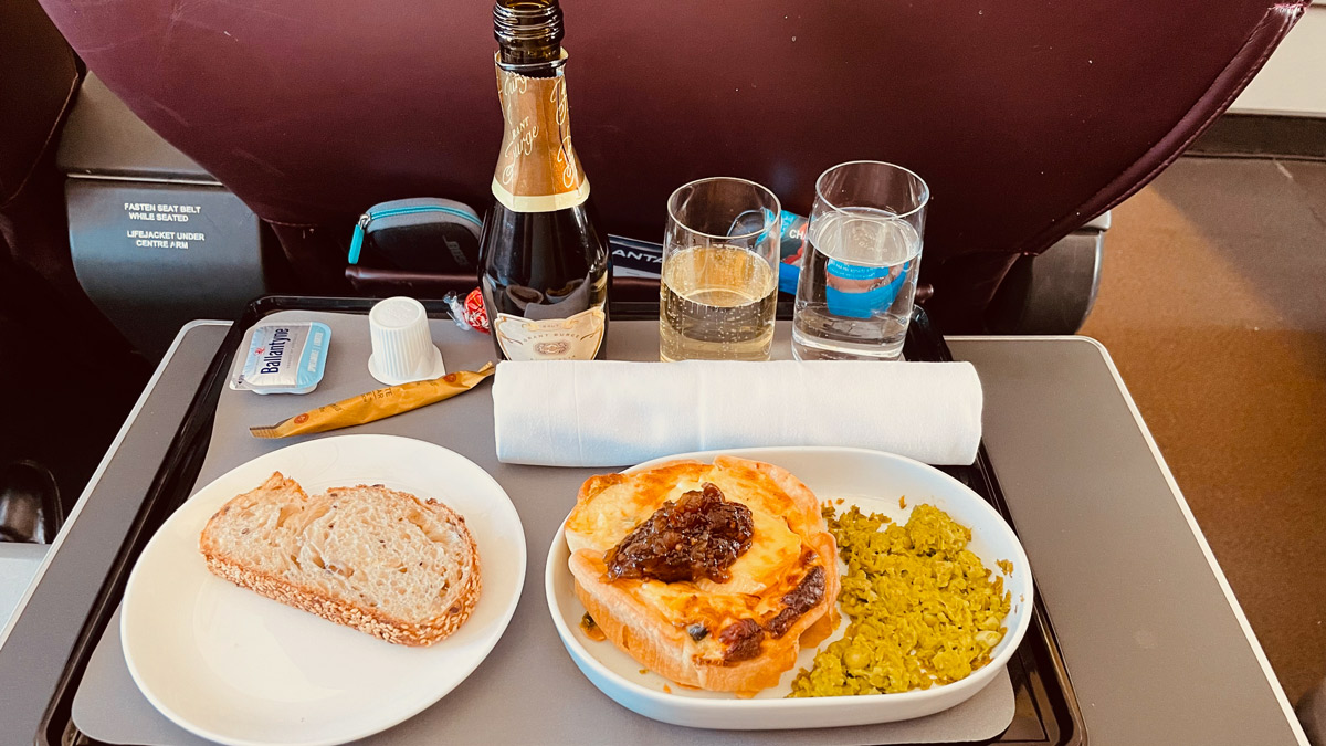 a plate of food and glasses on a tray