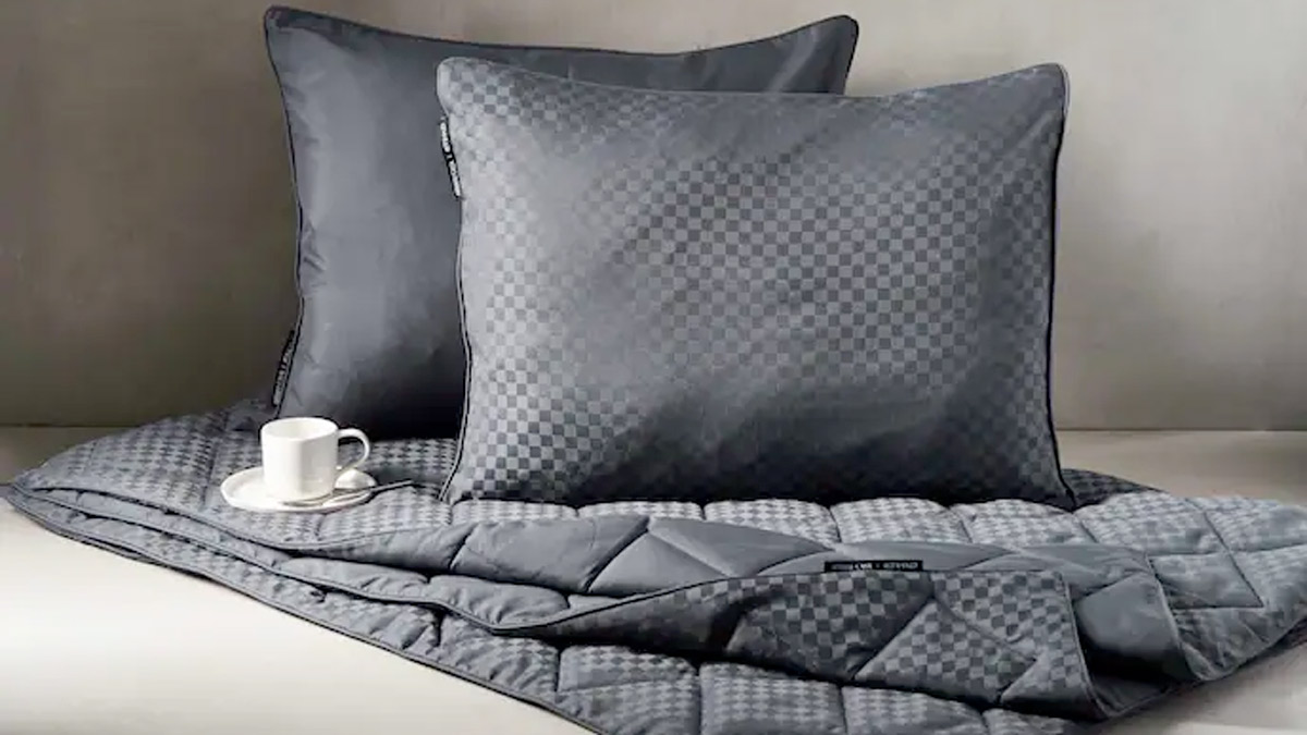 a pillow and a cup on a bed