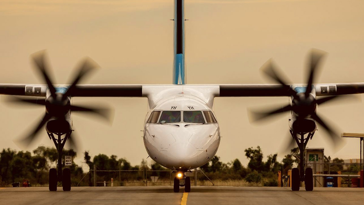 a white airplane on a runway