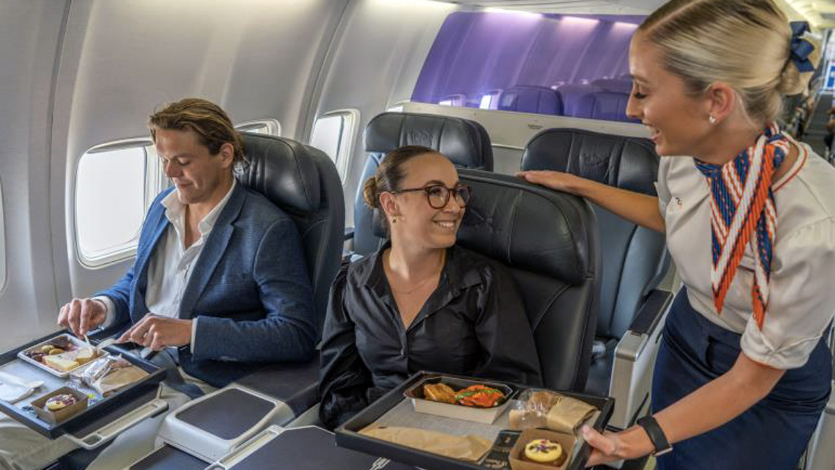 a woman sitting in a chair with a tray of food on her lap