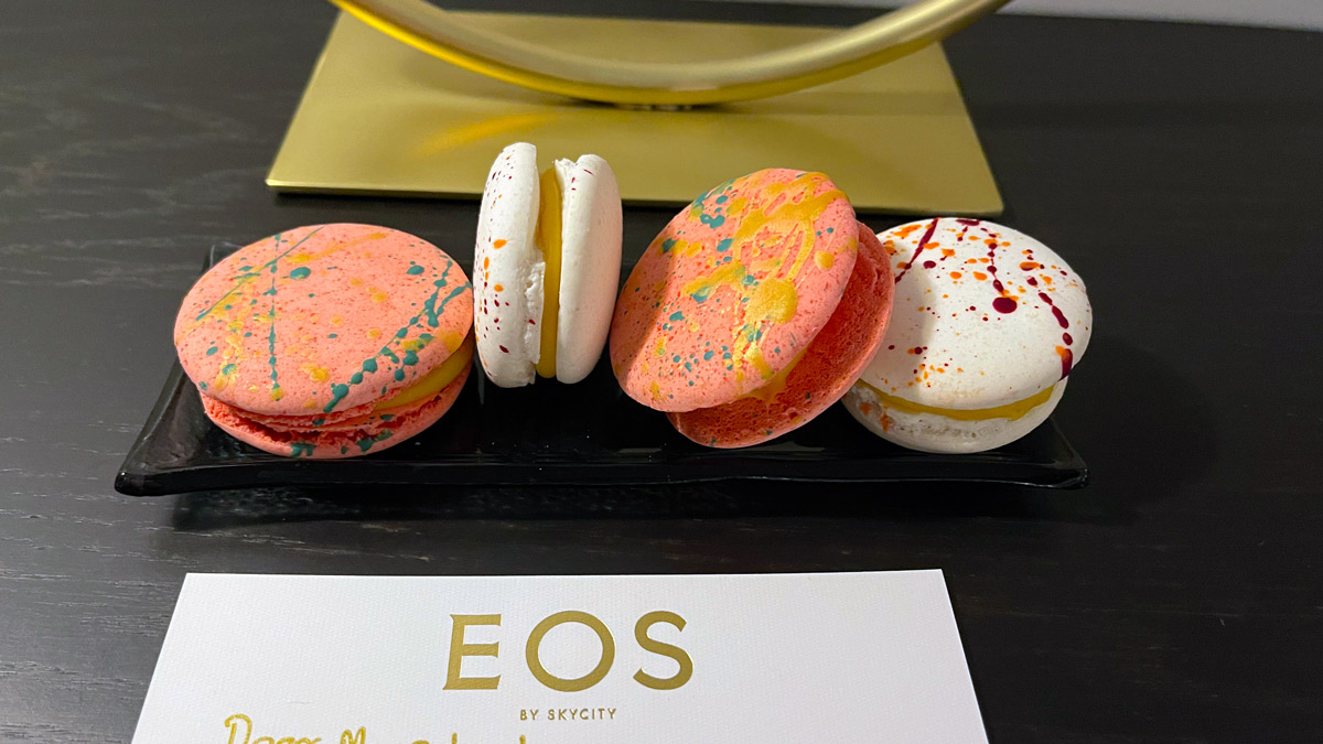 a group of colorful cookies on a black plate