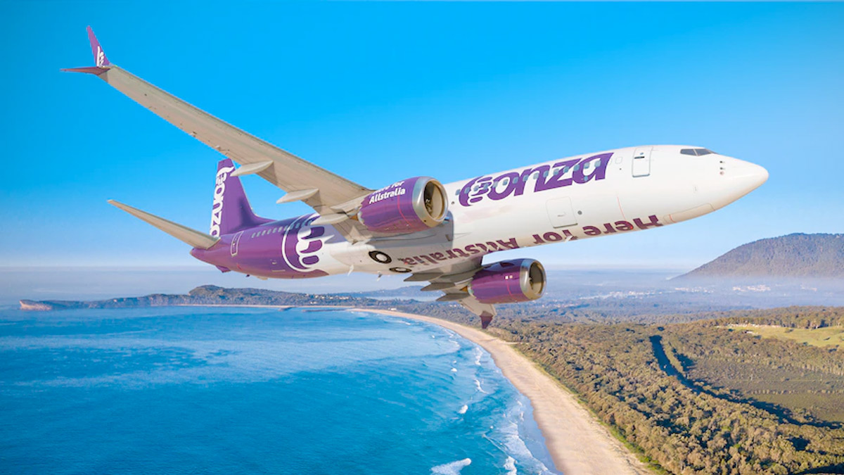 a plane flying over a beach