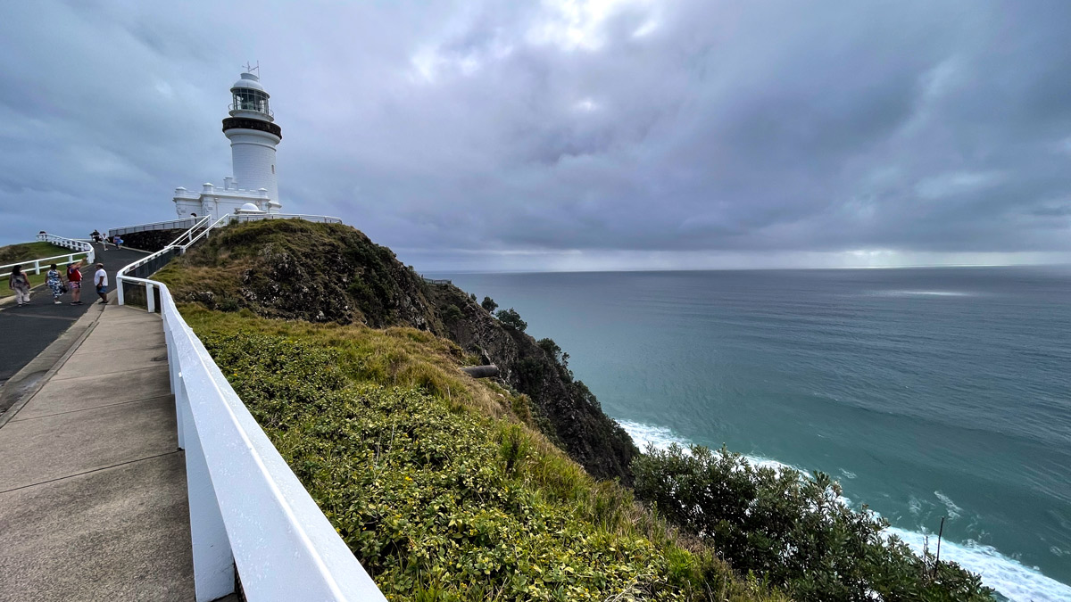 a lighthouse on a cliff overlooking the ocean