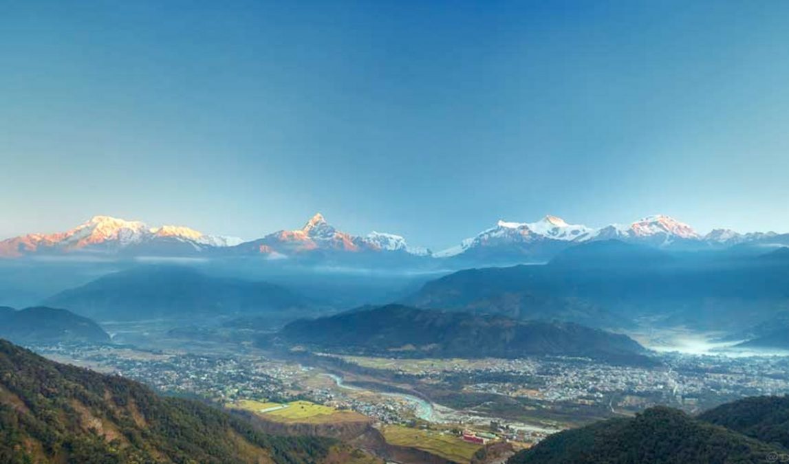 a valley with mountains in the background