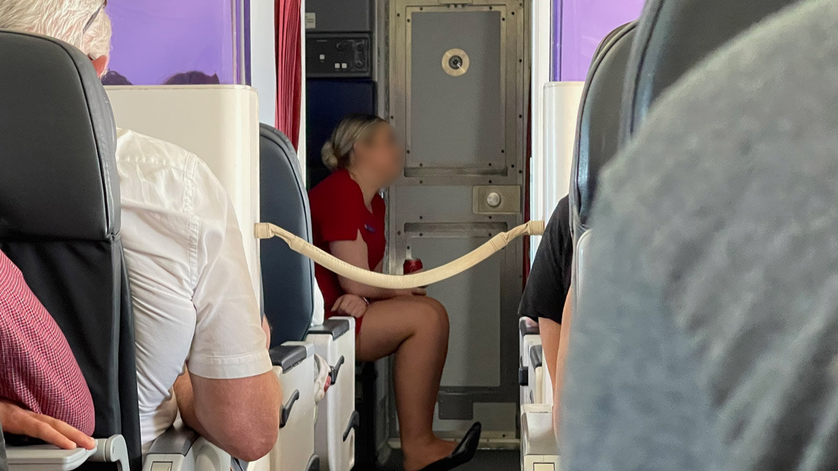 a woman sitting in a seat on an airplane