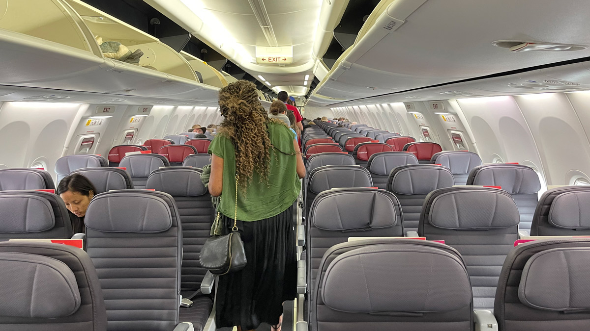 a woman walking in an airplane