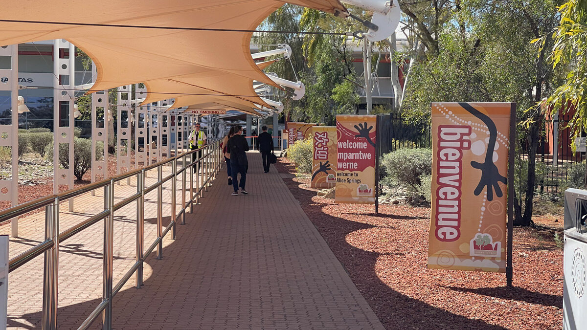 a group of people walking on a sidewalk