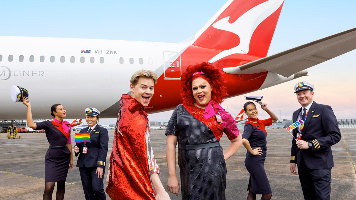 a group of people standing in front of a plane