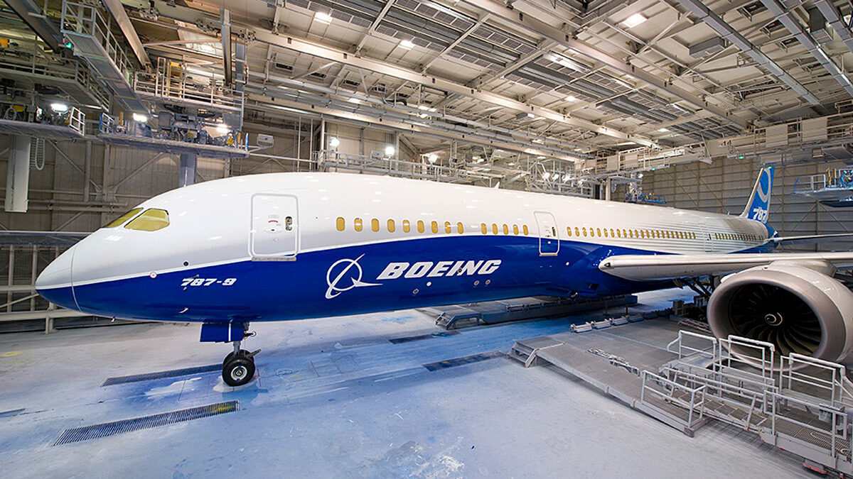 a blue and white airplane in a hangar