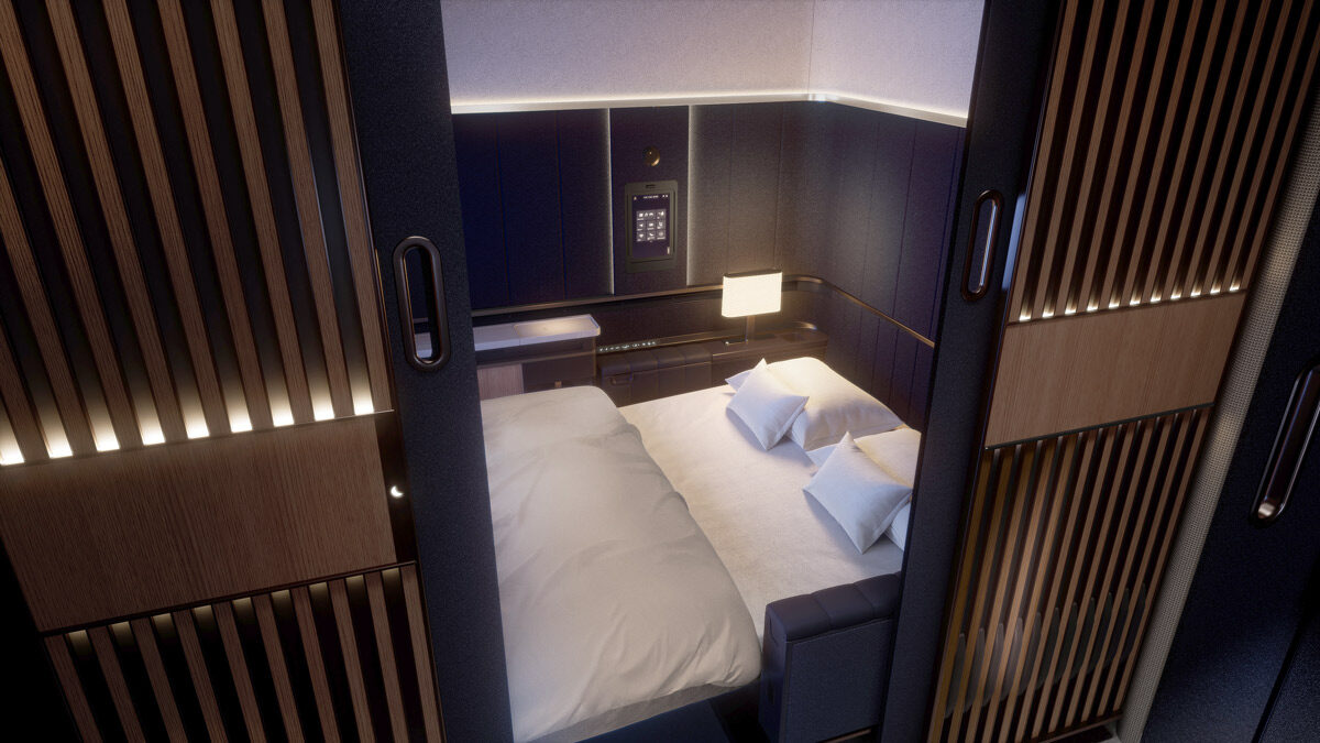 a bed with pillows and a lamp in a room