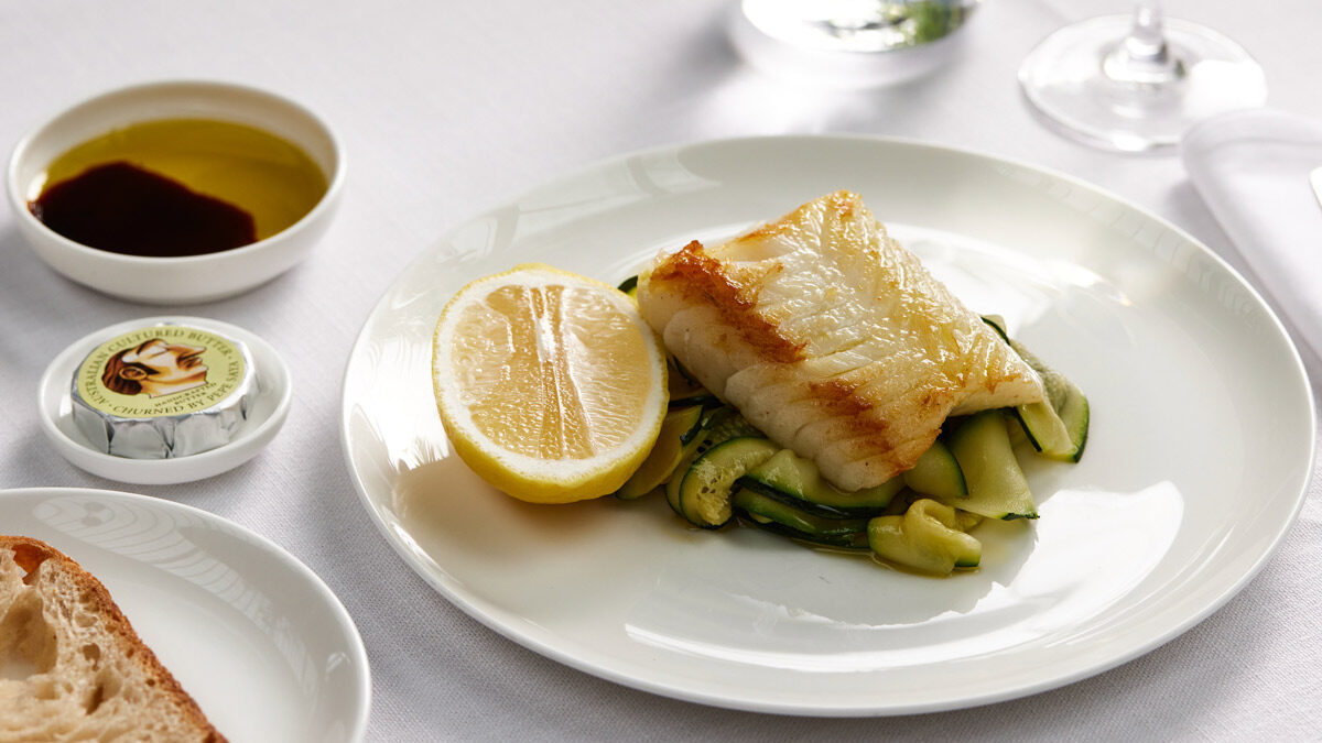 a plate of food with a lemon and zucchini