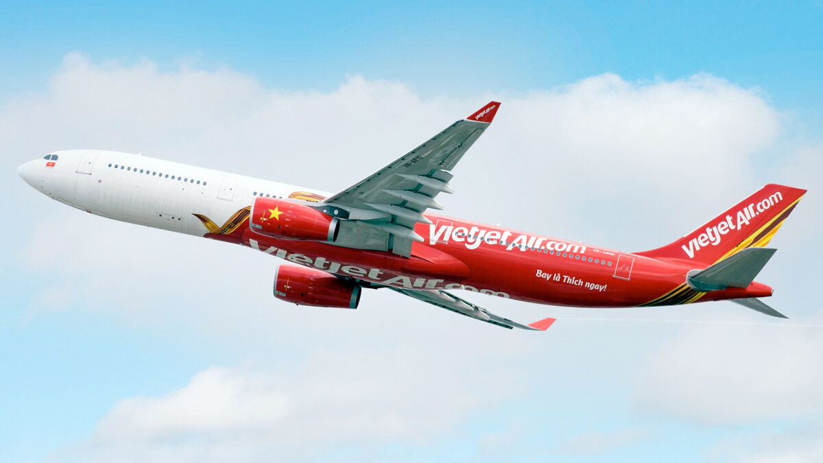 a red and white airplane flying in the sky