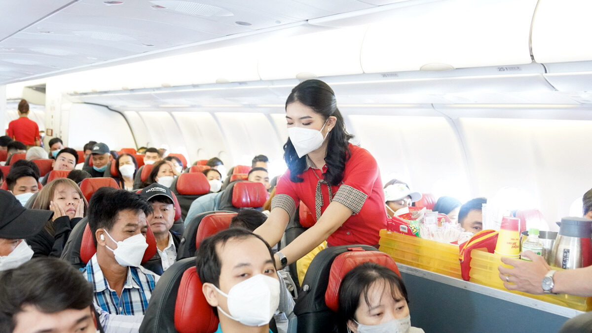 a woman wearing a mask on a plane