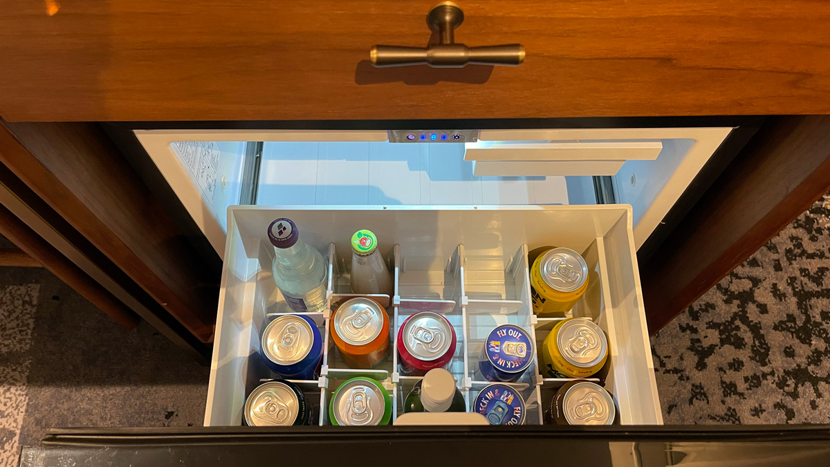 a open mini fridge with drinks in it
