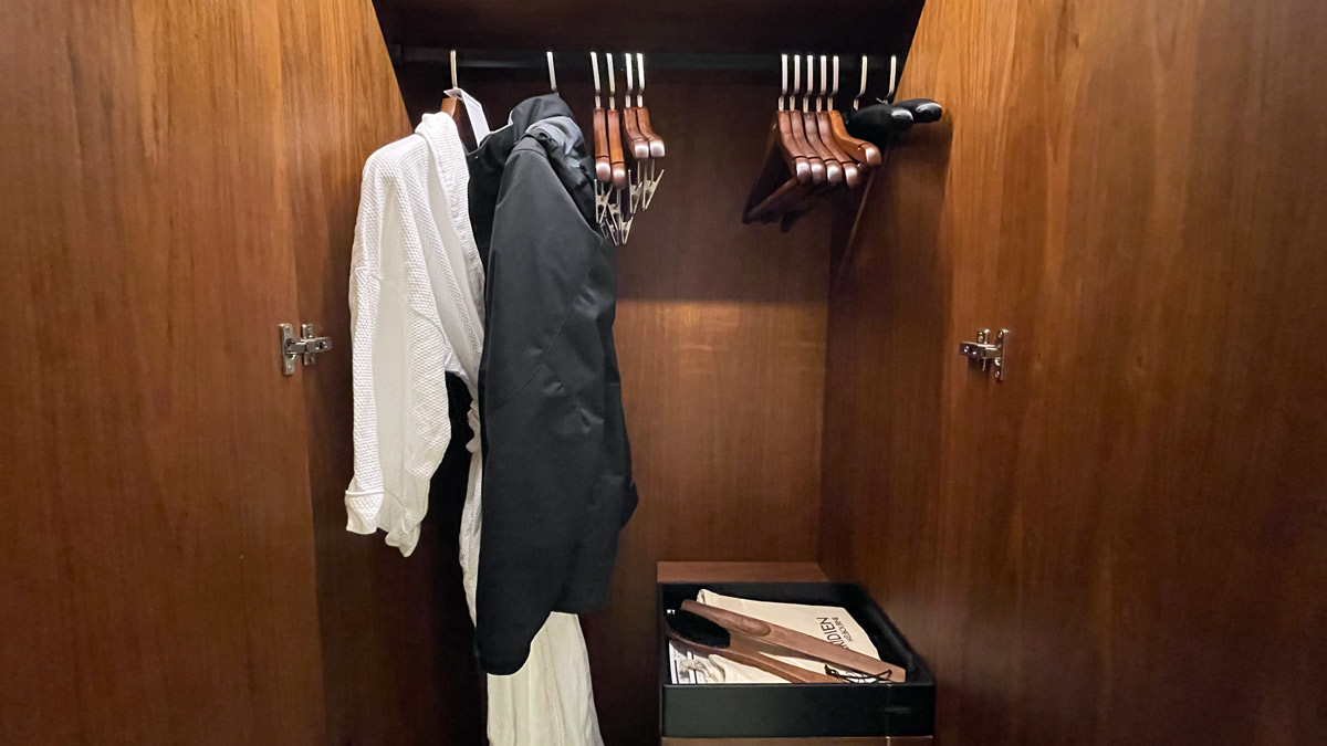 a closet with clothes on swingers