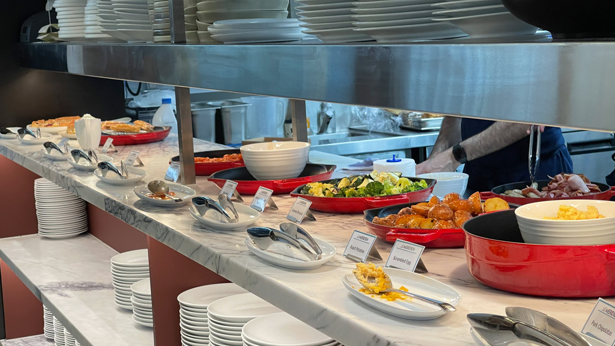 a buffet table with plates and bowls of food