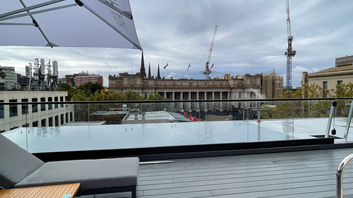 a balcony with a large building in the background