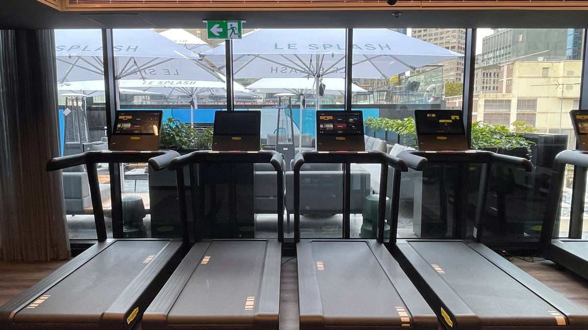 tread treadmills in a room with a view of a city