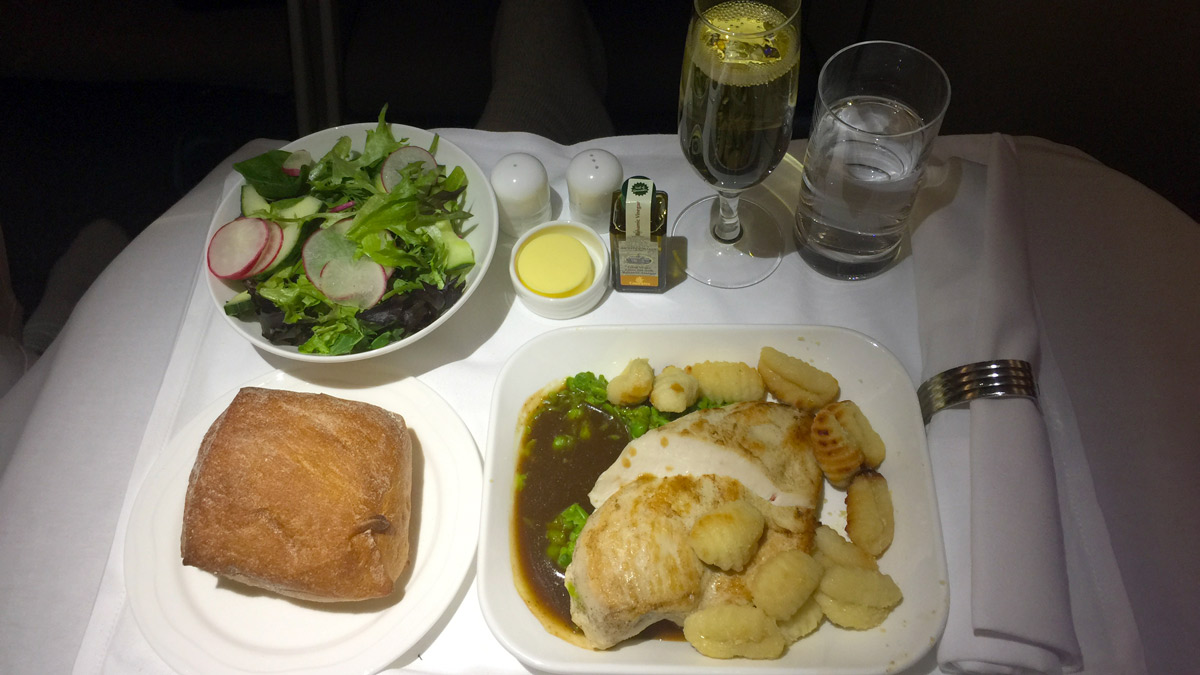 a plate of food and a salad on a table