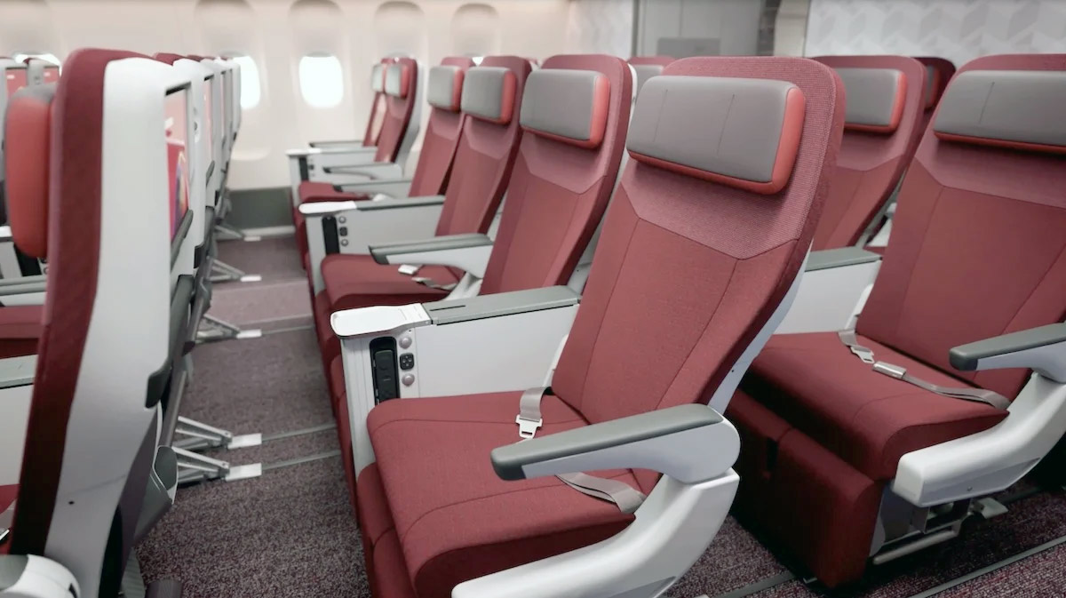 a row of red seats in an airplane