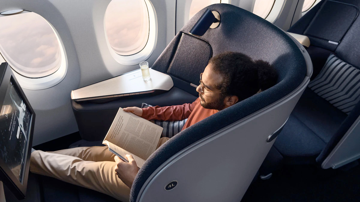 a man sitting in a chair reading a book