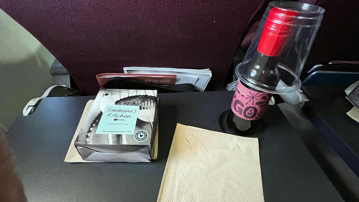 a bottle of wine and napkins on a table