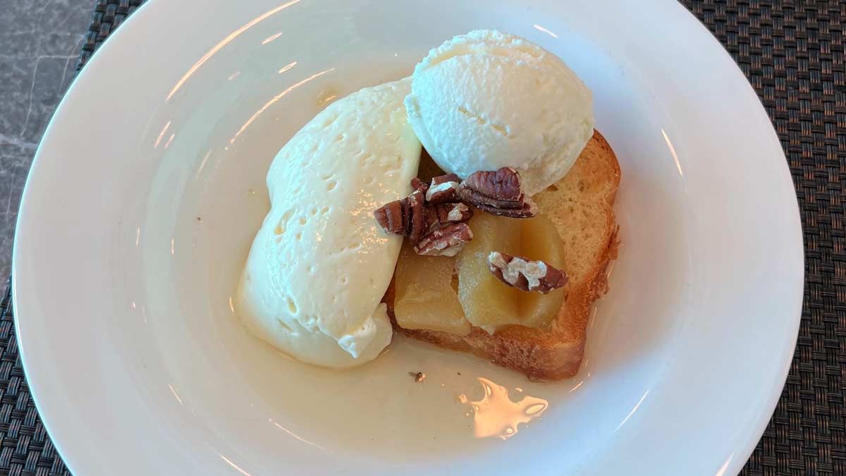 a plate of food with ice cream and nuts