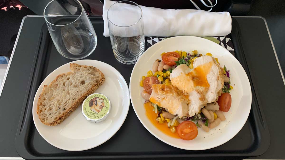 a plate of food and glasses on a tray