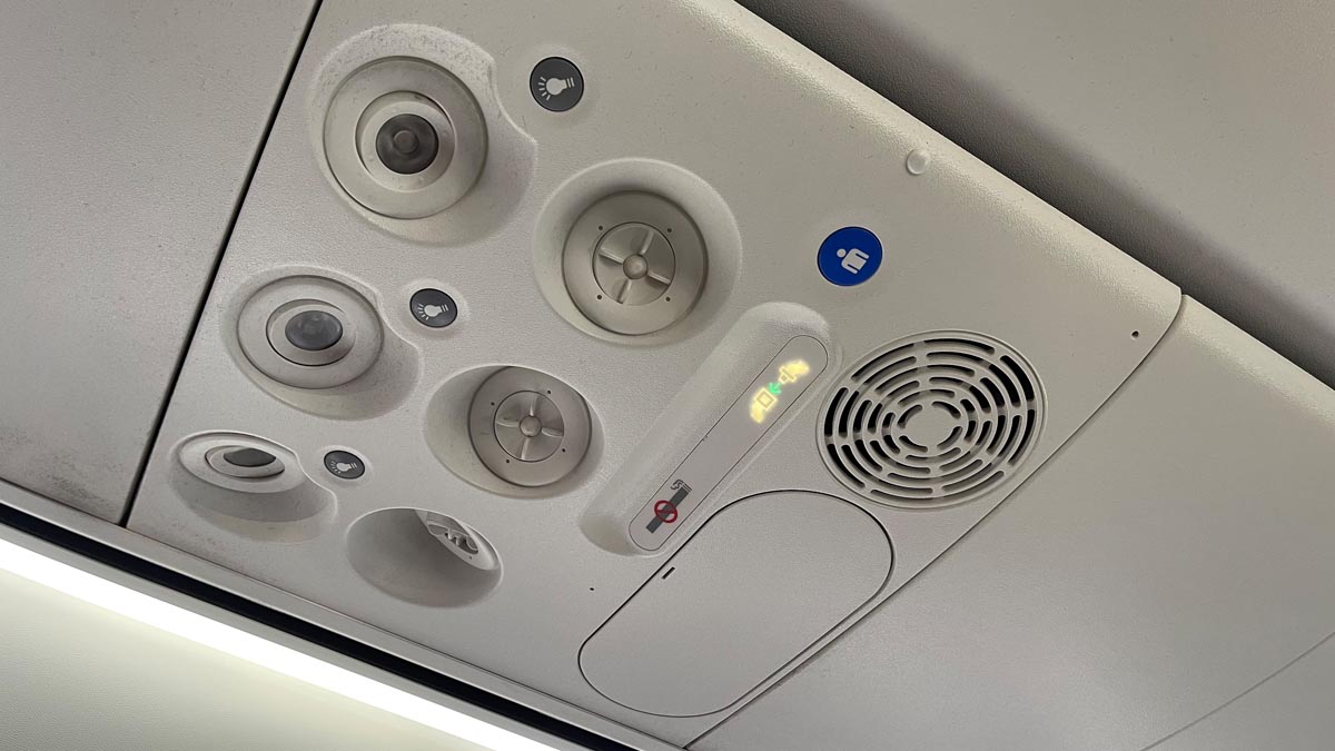 a white ceiling with lights and speakers