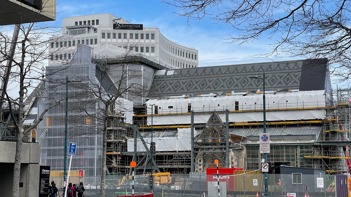 a building under construction with a building behind it