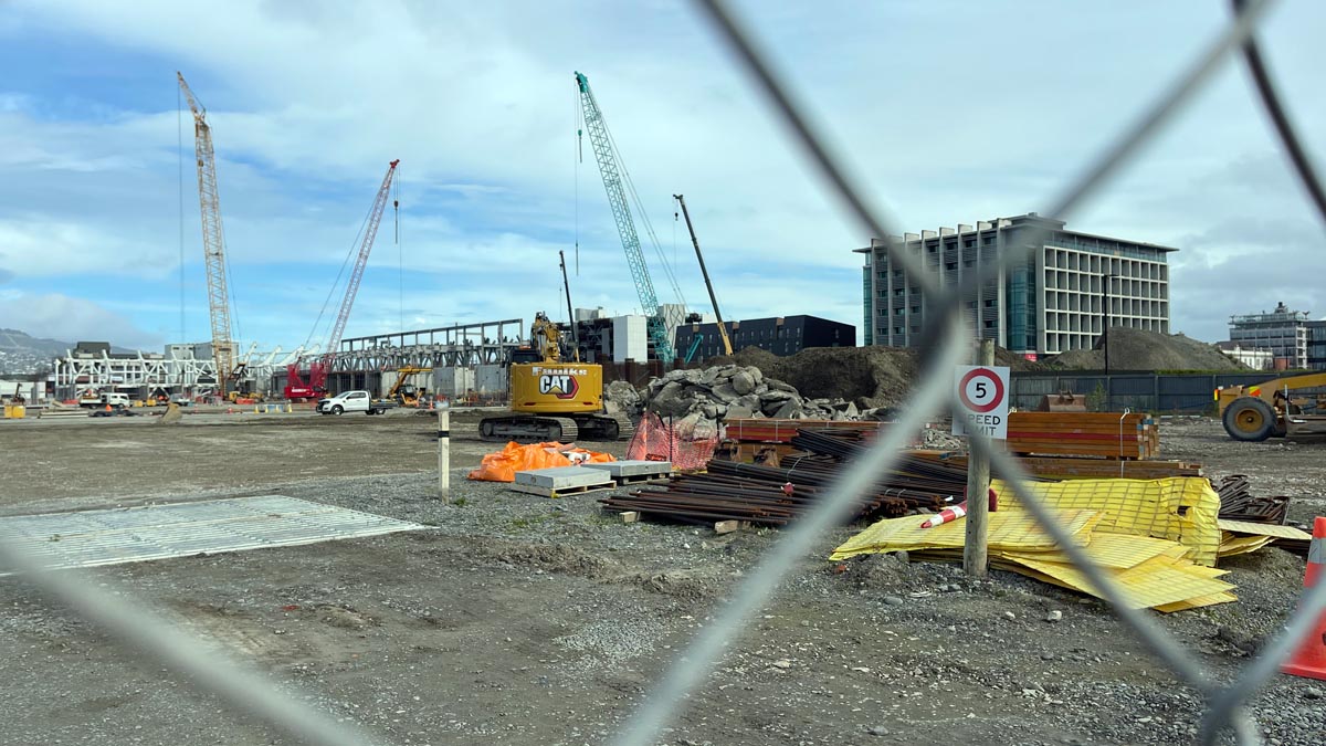 a construction site with cranes and a building