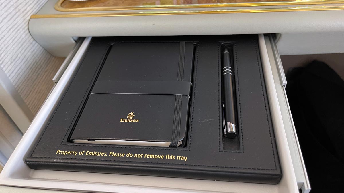 a black notebook and pen in a tray