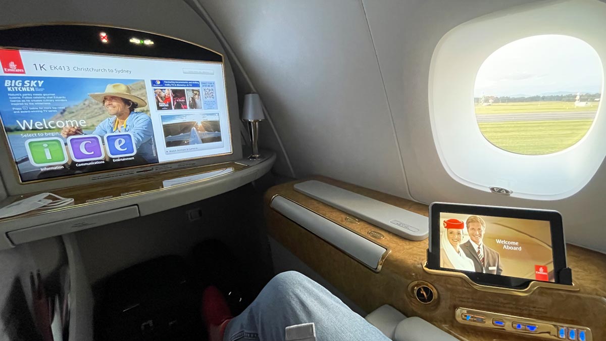 a person's legs in a chair with a tv and a screen