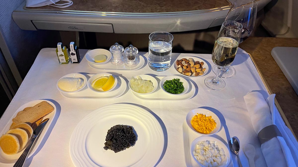 a table with plates of food and glasses of water