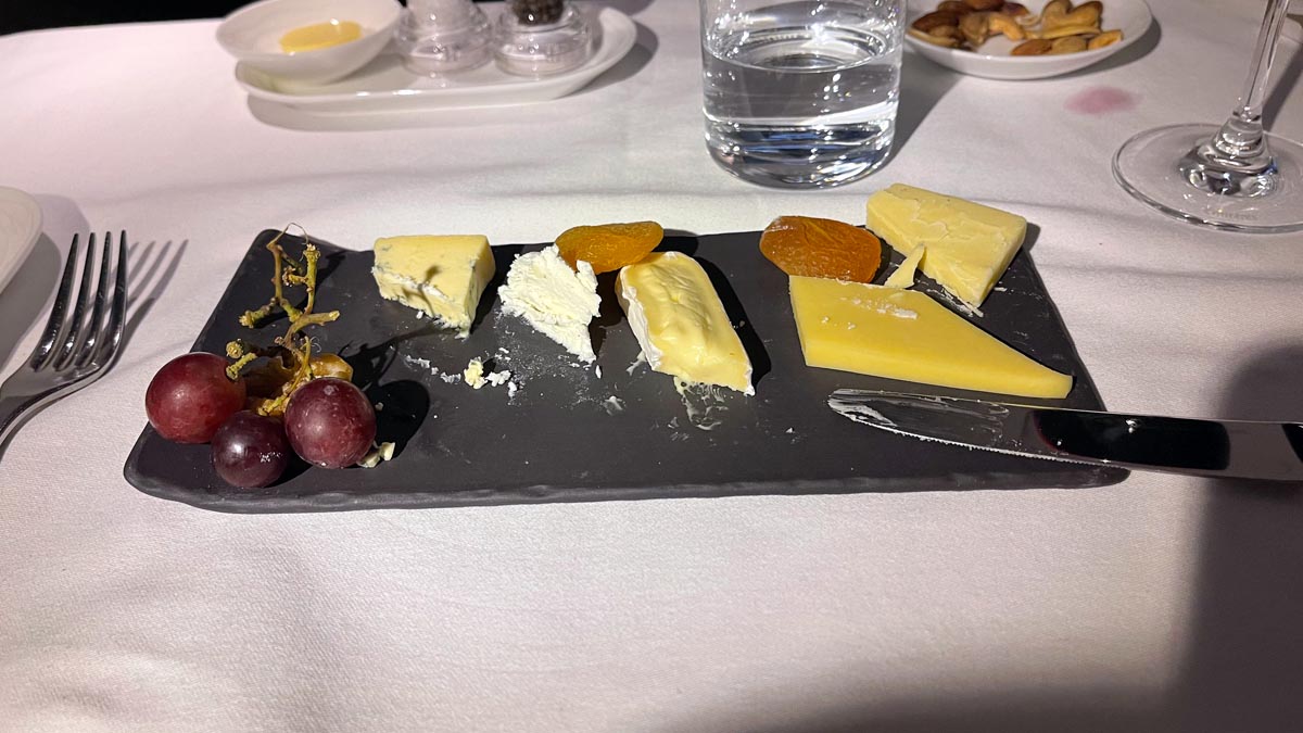 a plate of cheese and grapes