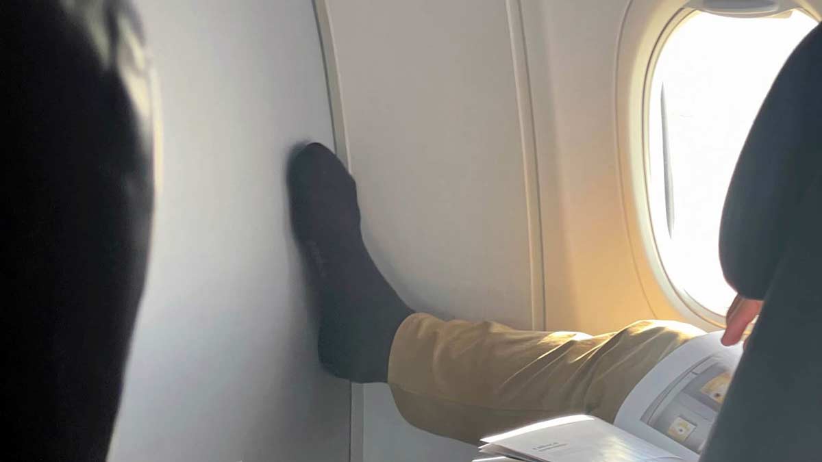 a person's foot on a plane