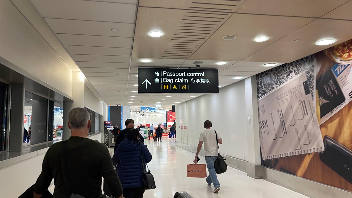 people walking in a hallway with signs and people