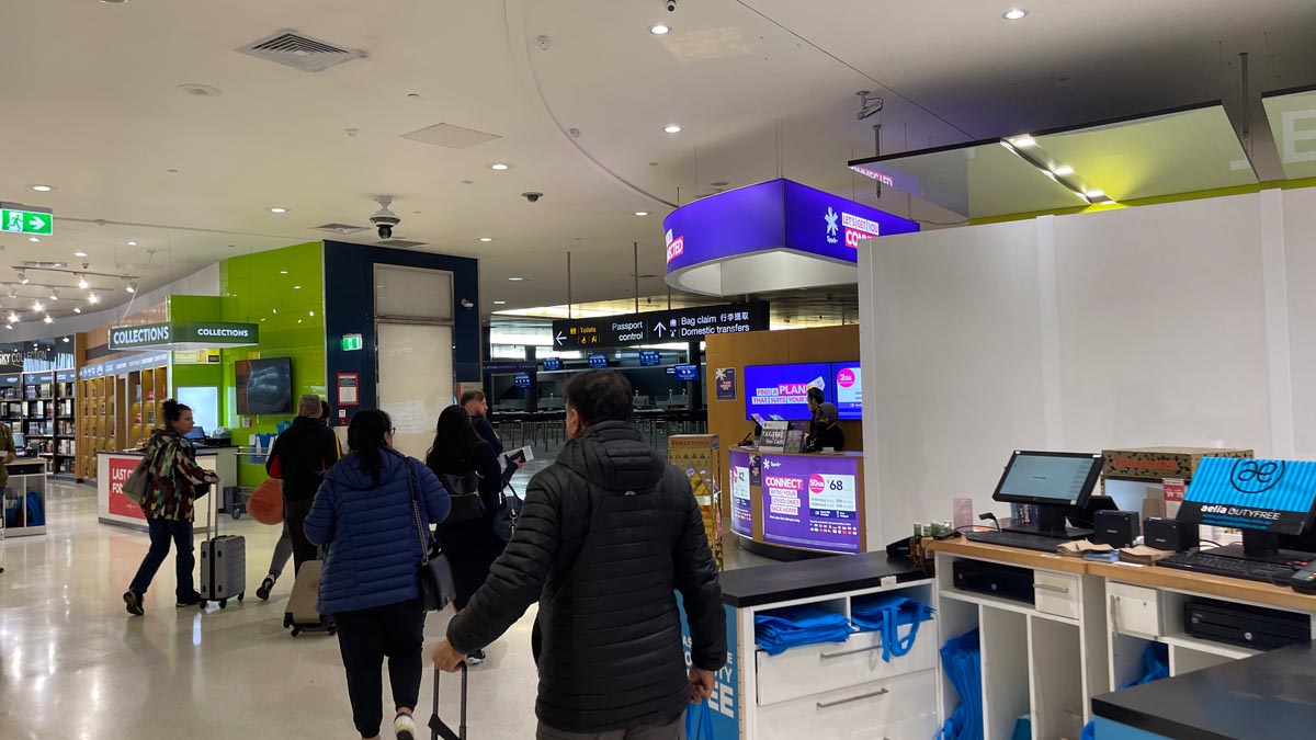 people in a building with people standing in front of a counter