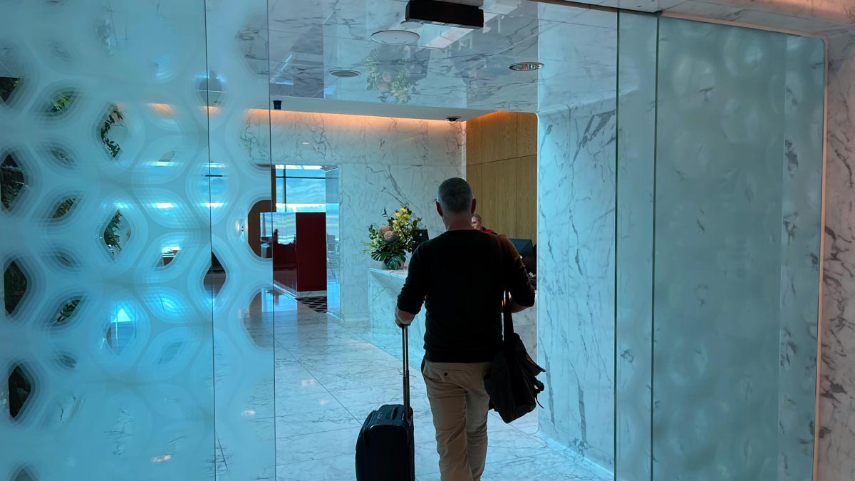 a man walking with a luggage in a hotel lobby