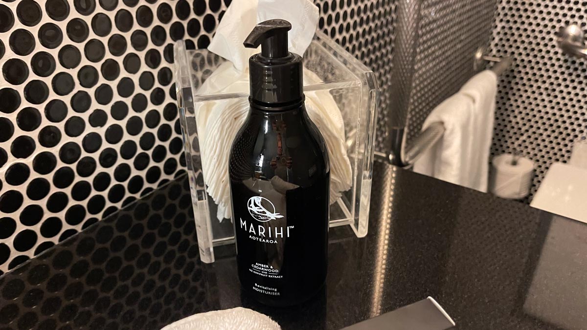 a black bottle of liquid on a black counter