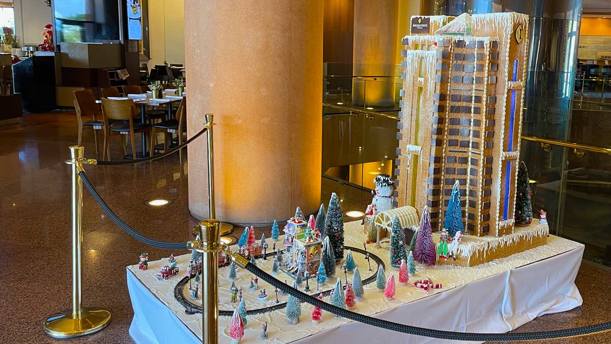 a model train display with a gingerbread building and trees