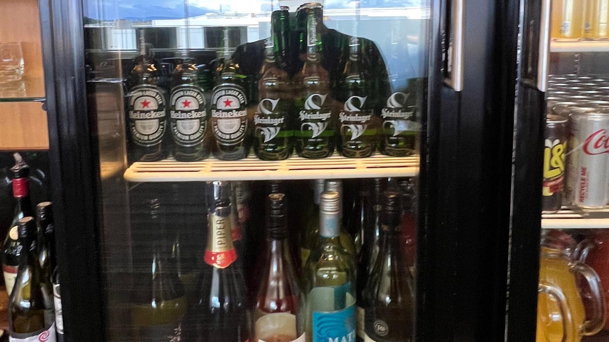 a shelf of bottles of alcohol
