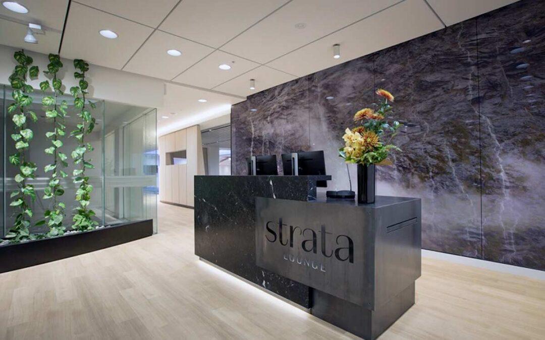 a black marble reception desk with flowers in front of it